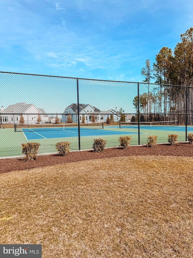 view of sport court featuring fence