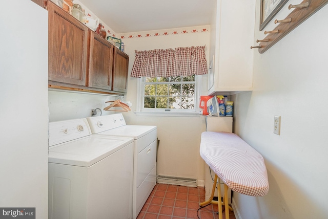 clothes washing area with cabinet space, tile patterned flooring, and washing machine and clothes dryer