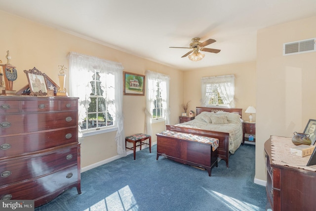 carpeted bedroom featuring baseboards, visible vents, and a ceiling fan