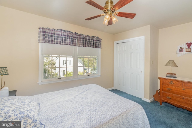 carpeted bedroom with ceiling fan, baseboards, and a closet