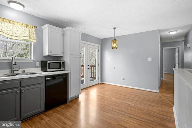 kitchen featuring gray cabinetry, a sink, stainless steel microwave, french doors, and dishwasher