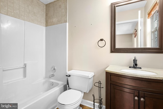 full bathroom featuring baseboards, toilet, bathtub / shower combination, and vanity