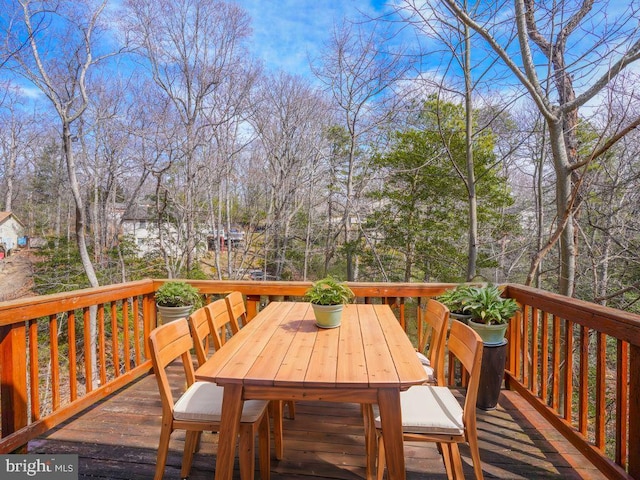 wooden terrace with outdoor dining space