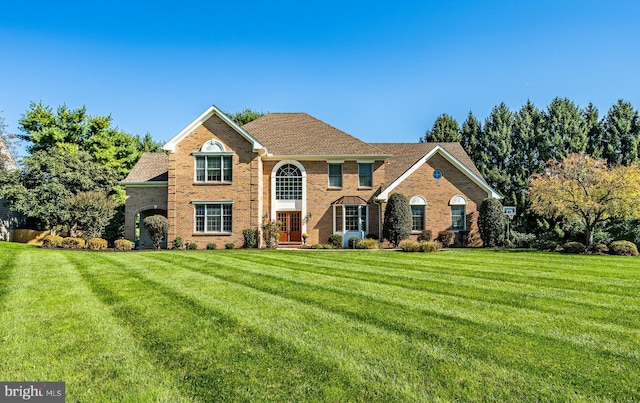 view of front facade featuring a front lawn and brick siding