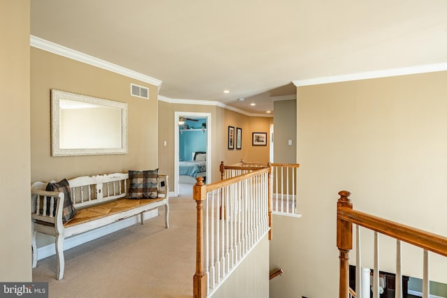 hallway featuring visible vents, recessed lighting, crown molding, carpet flooring, and an upstairs landing