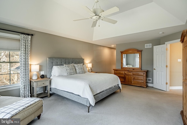 bedroom featuring visible vents, light carpet, baseboards, and a ceiling fan