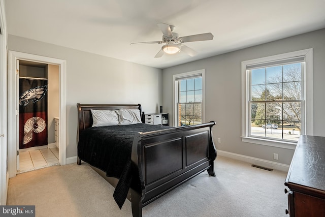 bedroom with ceiling fan, baseboards, visible vents, and light carpet