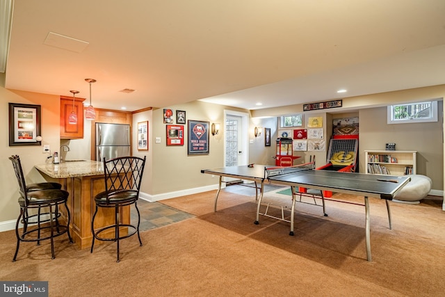 rec room with recessed lighting, indoor wet bar, baseboards, and light colored carpet