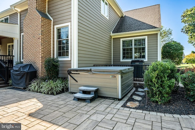 view of patio featuring a grill and a hot tub