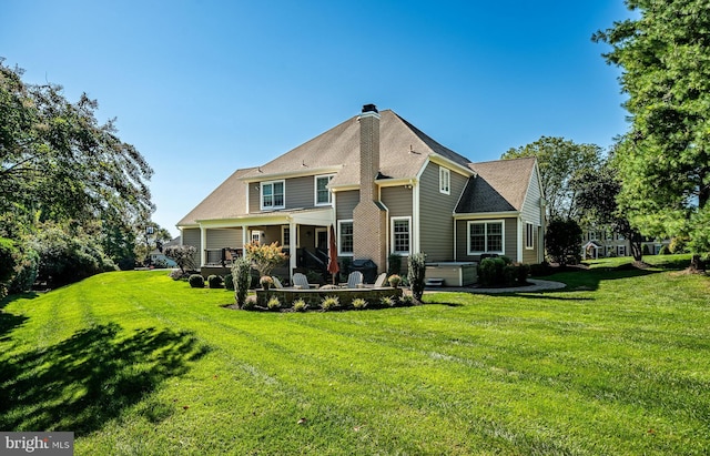 rear view of house with a lawn and a chimney