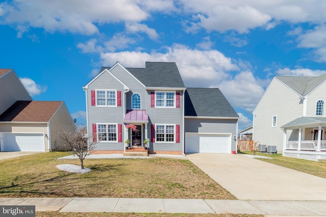 colonial-style house featuring a shingled roof, a front yard, central AC unit, a garage, and driveway