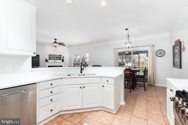 kitchen with a ceiling fan, a sink, appliances with stainless steel finishes, crown molding, and light countertops