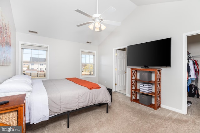 bedroom with a walk in closet, visible vents, a ceiling fan, a closet, and carpet floors