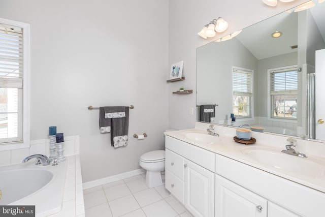 bathroom featuring a sink, lofted ceiling, a tub, and tile patterned floors