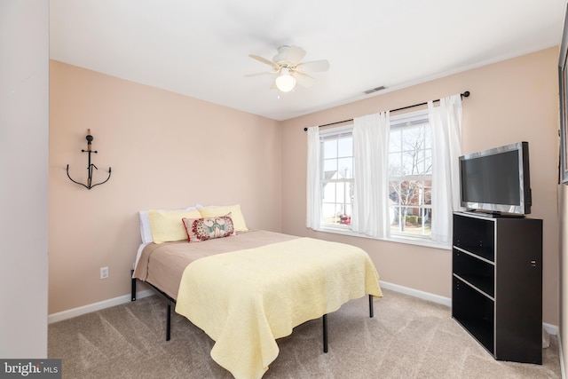 bedroom with carpet flooring, visible vents, baseboards, and ceiling fan