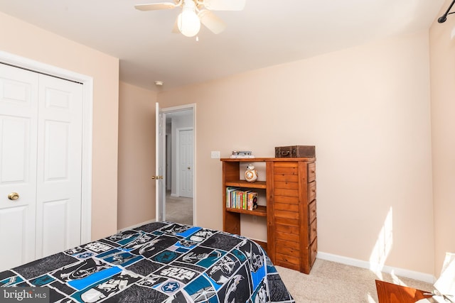 carpeted bedroom featuring baseboards, a closet, and ceiling fan