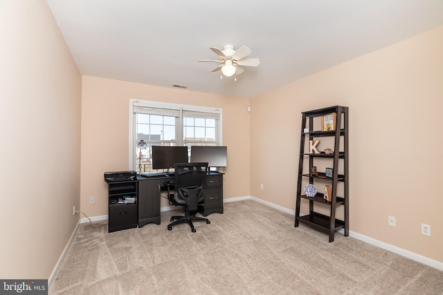 office space with carpet flooring, visible vents, baseboards, and ceiling fan