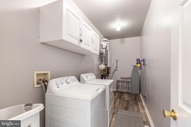 clothes washing area featuring baseboards, cabinet space, dark wood-style flooring, and washing machine and clothes dryer