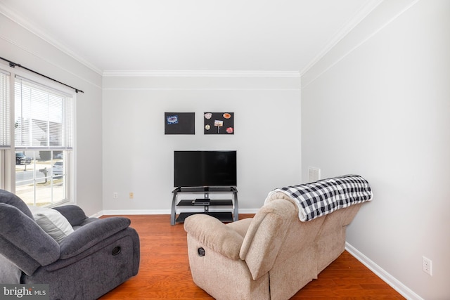 living room with baseboards, wood finished floors, and crown molding