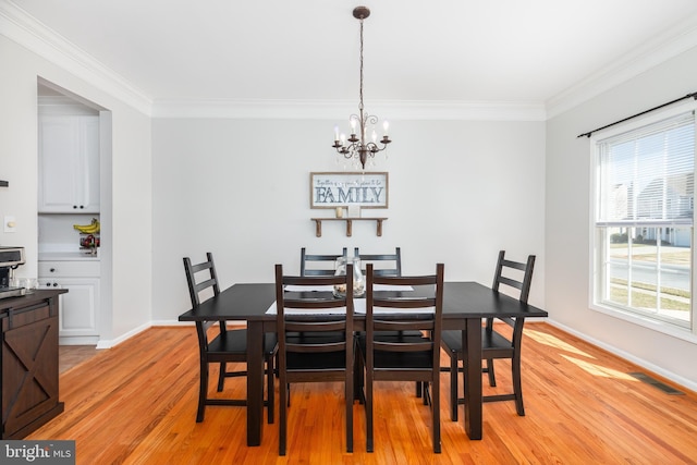 dining space featuring a wealth of natural light, visible vents, light wood-type flooring, and ornamental molding