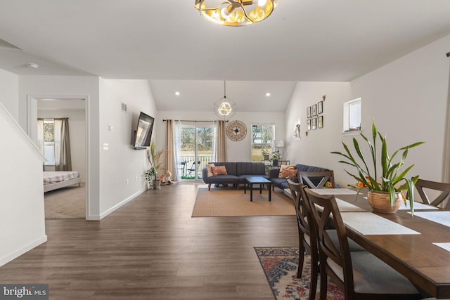 dining space featuring recessed lighting, lofted ceiling, and wood finished floors