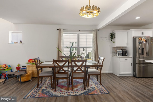 dining area with recessed lighting, baseboards, dark wood-type flooring, and an inviting chandelier