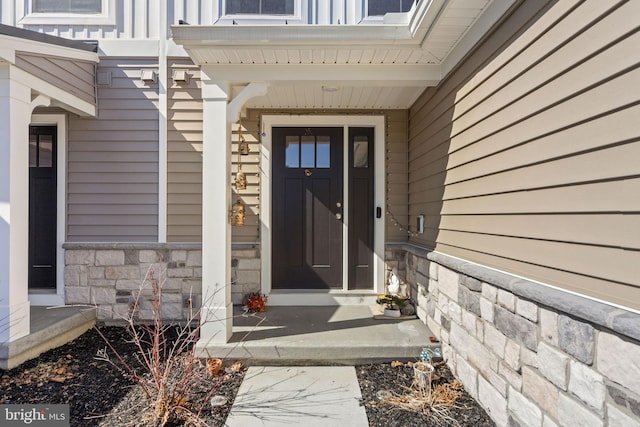 doorway to property with stone siding