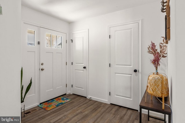 foyer entrance with visible vents and wood finished floors