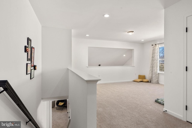 hall with recessed lighting, baseboards, an upstairs landing, and carpet floors