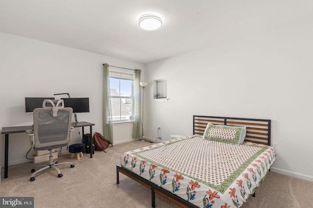 bedroom with carpet flooring and baseboards