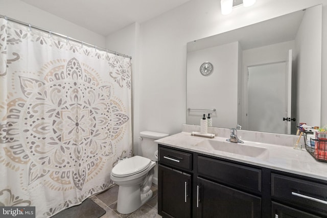 full bathroom with vanity, tile patterned floors, curtained shower, and toilet