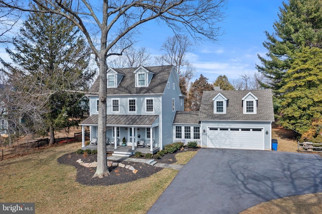 view of front of house featuring driveway, covered porch, a front yard, a shingled roof, and a garage