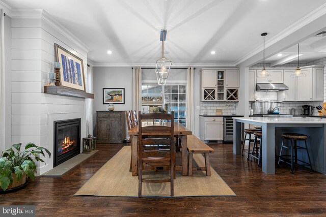 631 Monument Ave, Malvern, PA 19355 - dining space featuring dark wood-style floors, recessed lighting, wine cooler, a fireplace, and crown molding