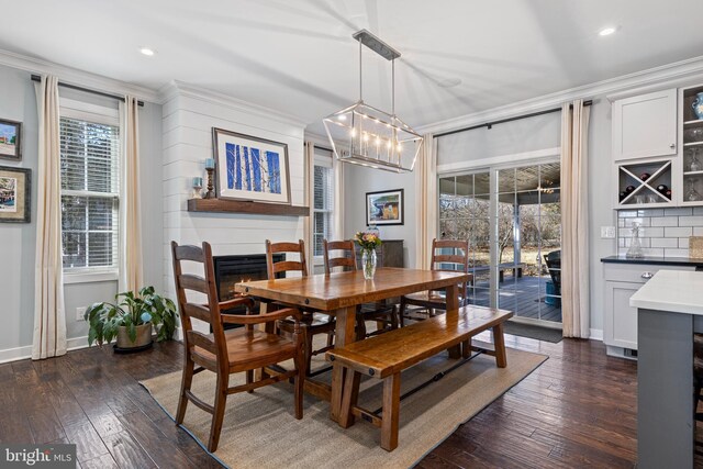 631 Monument Ave, Malvern, PA 19355 - dining room featuring crown molding, a healthy amount of sunlight, and a warm lit fireplace