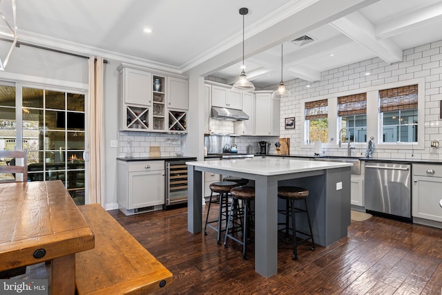 631 Monument Ave, Malvern, PA 19355 - kitchen featuring a kitchen bar, beam ceiling, beverage cooler, under cabinet range hood, and stainless steel dishwasher