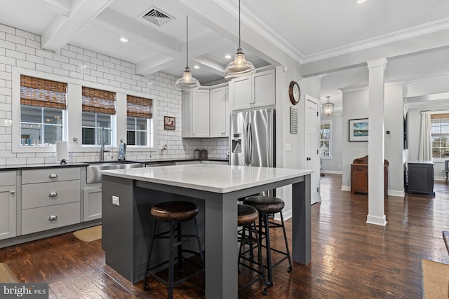 631 Monument Ave, Malvern, PA 19355 - kitchen featuring visible vents, beamed ceiling, decorative columns, stainless steel fridge, and a sink