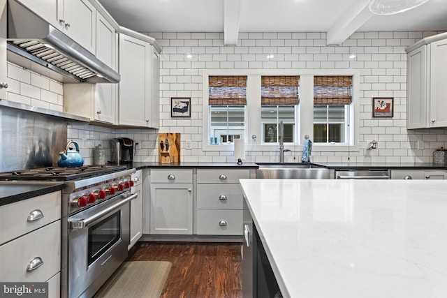 631 Monument Ave, Malvern, PA 19355 - kitchen with under cabinet range hood, beam ceiling, decorative backsplash, stainless steel appliances, and a sink