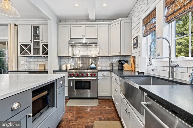 631 Monument Ave, Malvern, PA 19355 - kitchen with dark wood-style floors, recessed lighting, stainless steel appliances, decorative backsplash, and under cabinet range hood