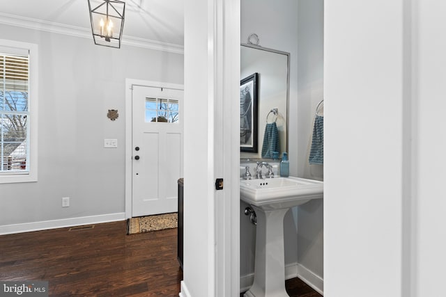 631 Monument Ave, Malvern, PA 19355 - foyer featuring an inviting chandelier, crown molding, baseboards, and dark wood-style flooring