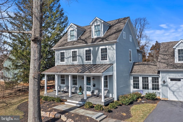 631 Monument Ave, Malvern, PA 19355 - view of front of house featuring fence, roof with shingles, a standing seam roof, a porch, and metal roof