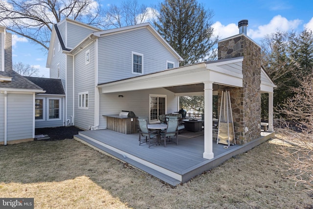 631 Monument Ave, Malvern, PA 19355 - rear view of property featuring a wooden deck, a lawn, and a chimney