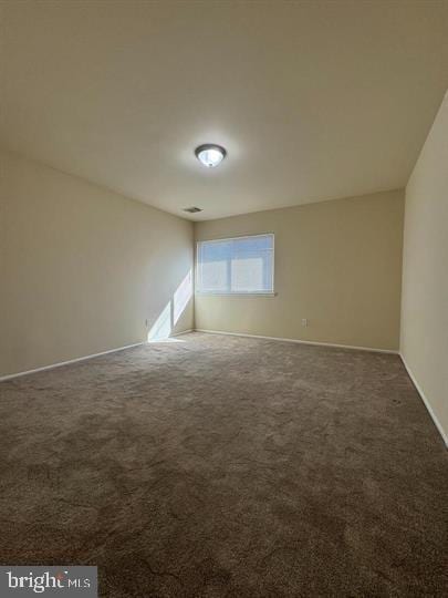 unfurnished room featuring visible vents, baseboards, and carpet flooring