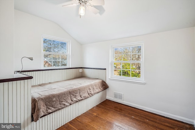 bedroom featuring visible vents, ceiling fan, baseboards, vaulted ceiling, and wood-type flooring