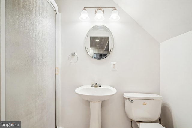 bathroom featuring toilet and vaulted ceiling