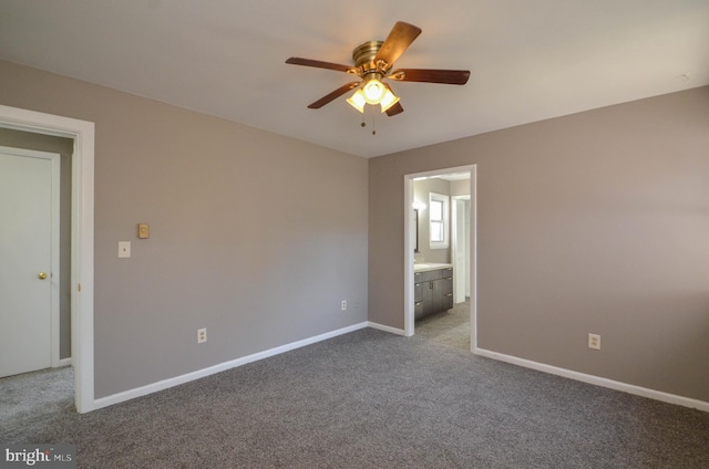 carpeted empty room with a ceiling fan and baseboards