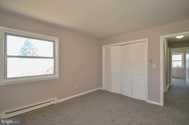 unfurnished bedroom featuring baseboards, carpet flooring, and baseboard heating