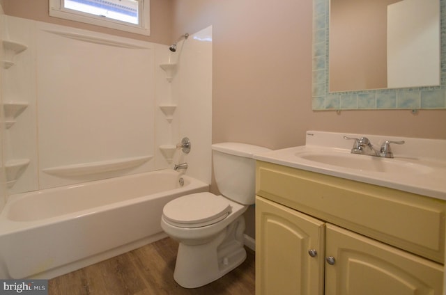 full bath featuring vanity, bathtub / shower combination, wood finished floors, and toilet