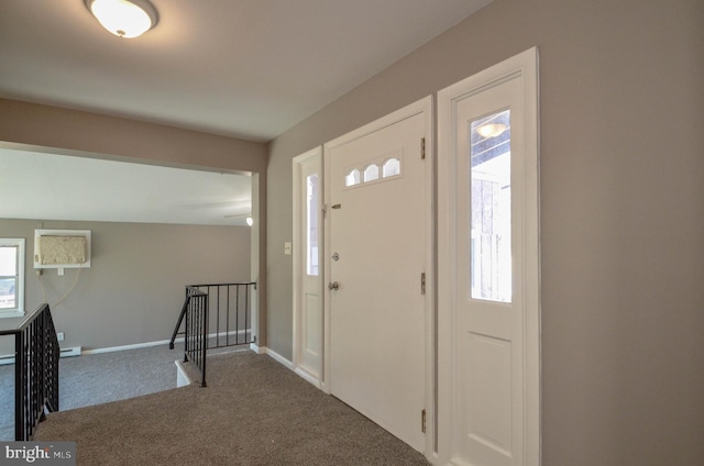 foyer entrance with carpet floors, baseboard heating, and baseboards