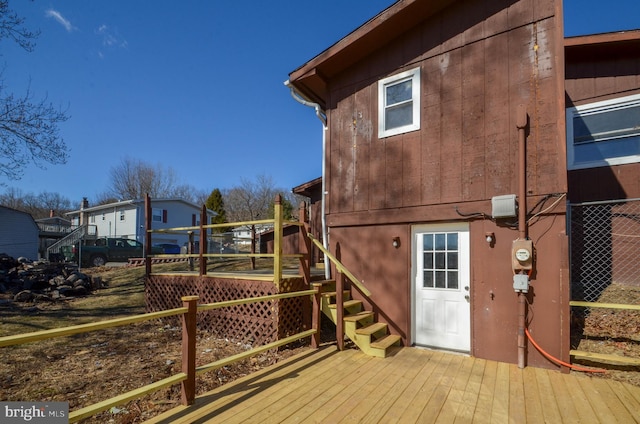 rear view of property featuring a wooden deck