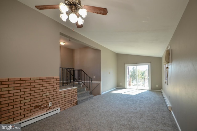 empty room featuring a baseboard heating unit, baseboards, vaulted ceiling, stairs, and carpet